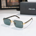 Square sunglasses with dark teal lenses and gold-tone frame