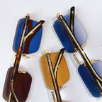 Assorted sunglasses with gold frames and blue and brown tinted lenses