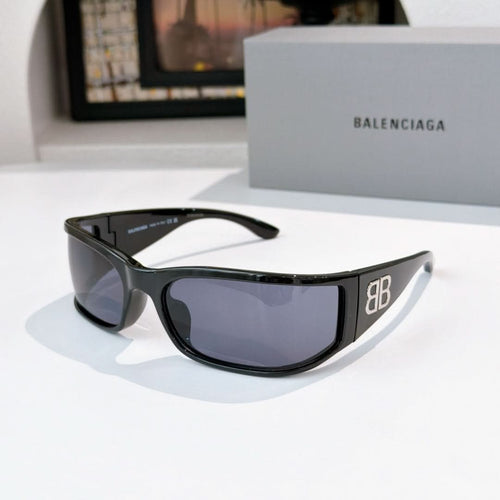 Balenciaga sunglasses with black frame and dark blue tinted lenses.