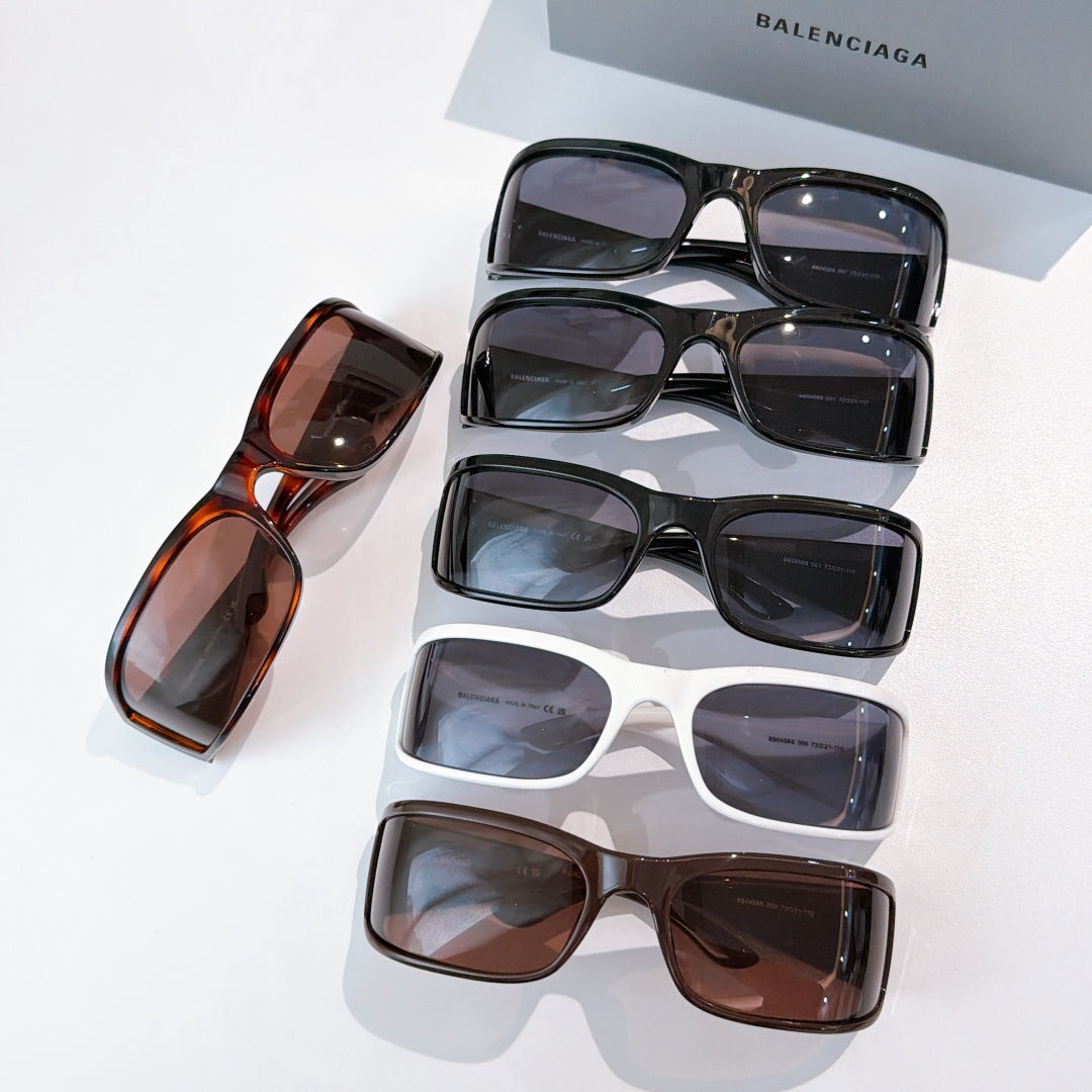 Balenciaga sunglasses collection with stacked frames in black, white, and brown.