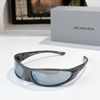 Balenciaga sunglasses with dark gray frames and light blue lenses, curved wrap style.