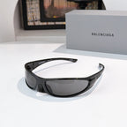 Balenciaga sunglasses with black frames and gray lenses, front view with wrap shape.
