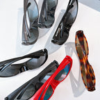 Assorted Balenciaga sunglasses with black, red, and tortoiseshell frames and tinted lenses.