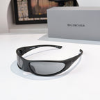 Balenciaga sunglasses with black frames and gray lenses, angled front with temple detail.