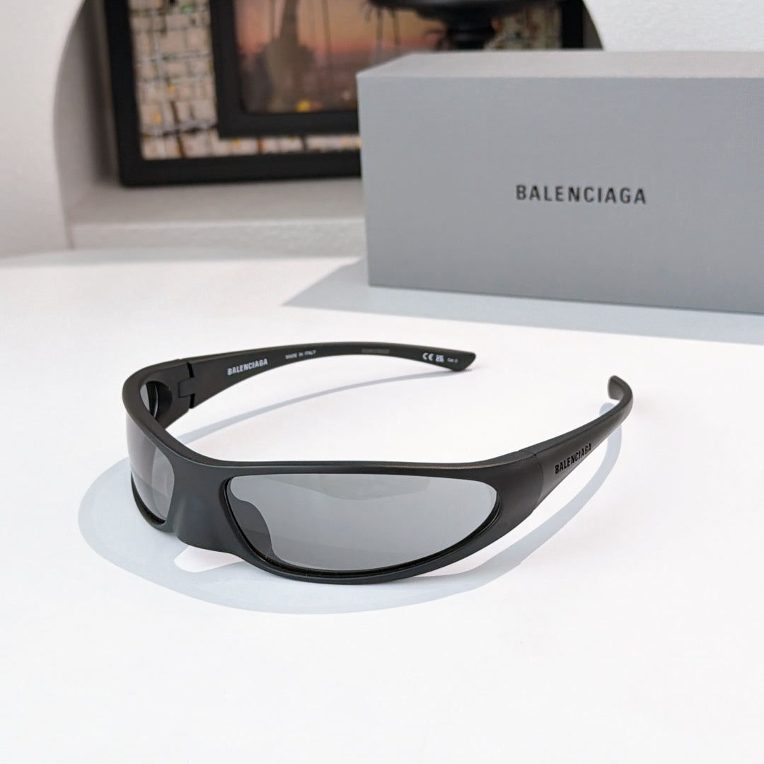 Balenciaga sunglasses with black frames and gray lenses, angled front with temple detail.
