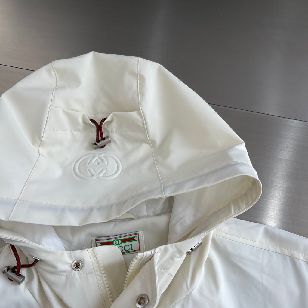 Cream hood with embroidered Gucci emblem and drawstring details