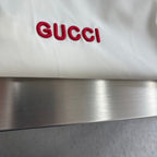 Cream Gucci logo patch with red 'GUCCI' lettering