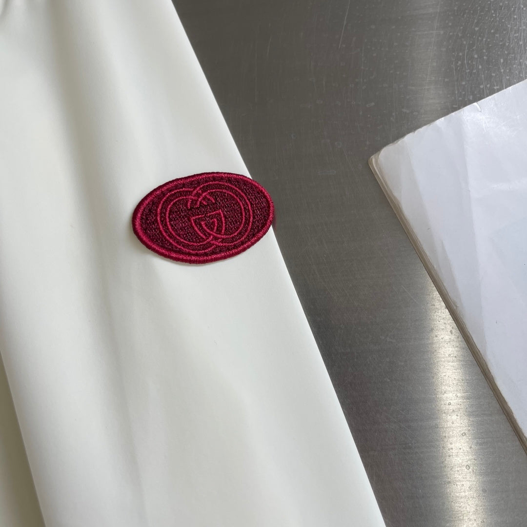 Cream jacket sleeve with burgundy Gucci GG round patch