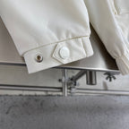Cream jacket cuff with snap button and small Gucci label