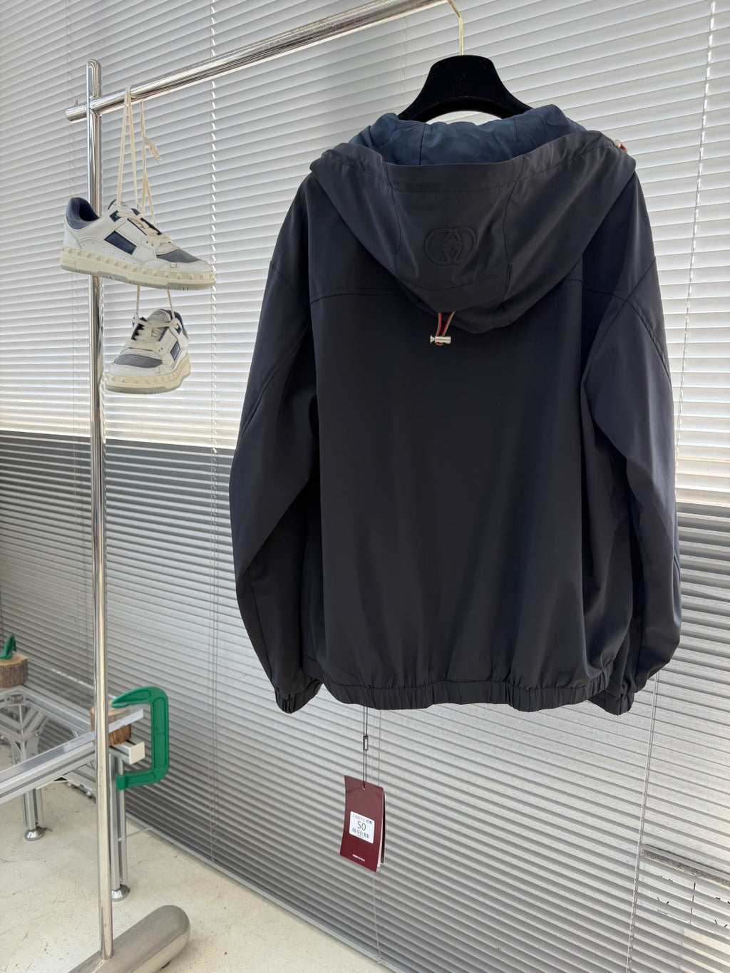 Gucci hooded jacket back view with embossed logo on the hood