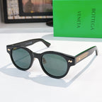 Sunglasses with black frame, blue lenses, and gold-patterned temples