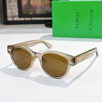 Sunglasses with light frame, brown lenses, and gold-patterned temples