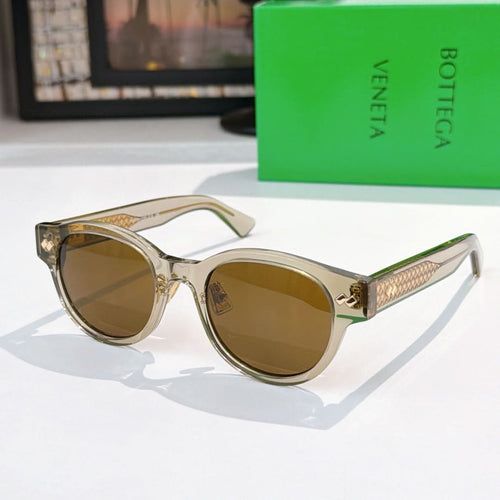 Sunglasses with light frame, brown lenses, and gold-patterned temples