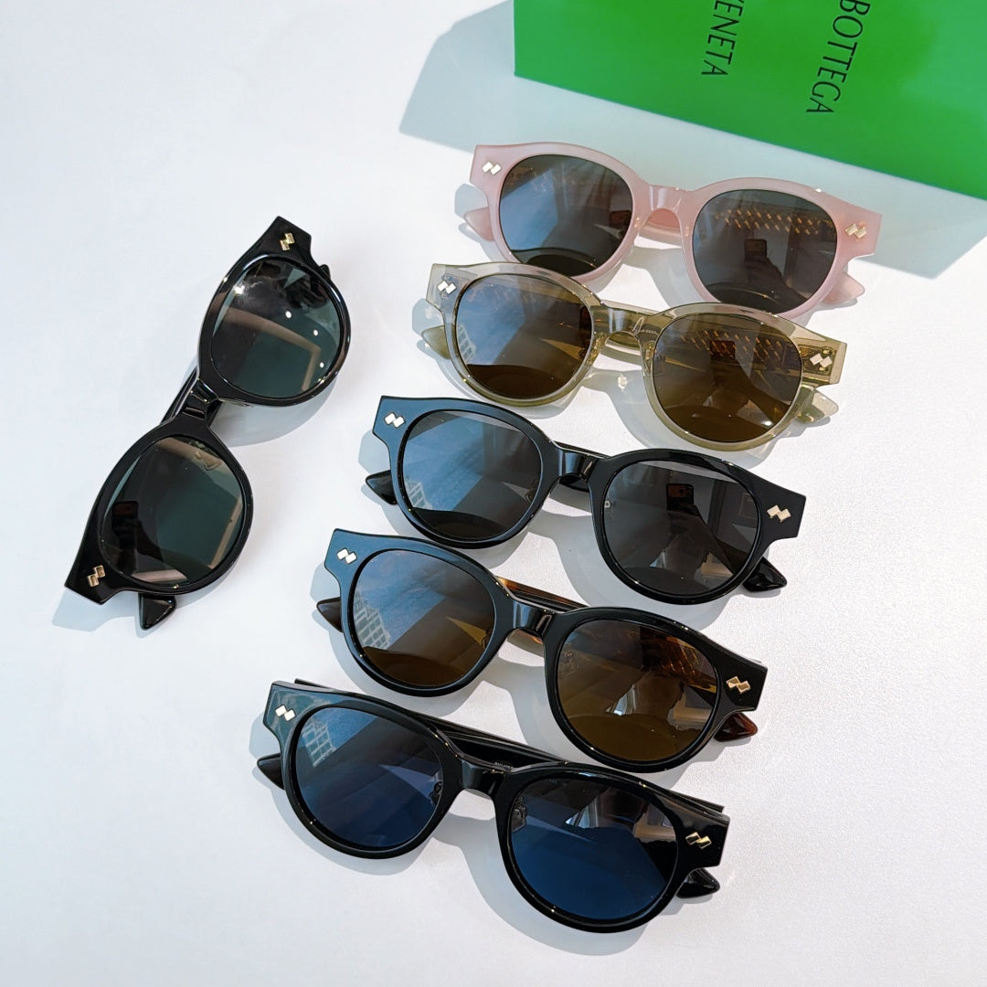 Assorted sunglasses with different frame colors and gold-patterned temples