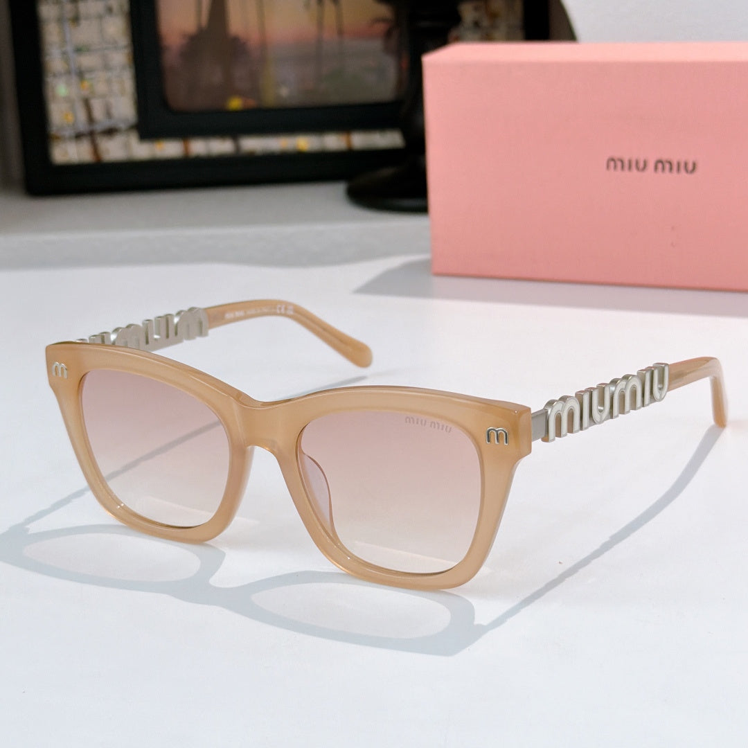 MiuMiu sunglasses with light tan frames, clear lenses, and gold logo on temple arms