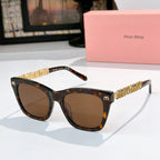 MiuMiu sunglasses with tortoiseshell frames, brown lenses, and gold logo on temples