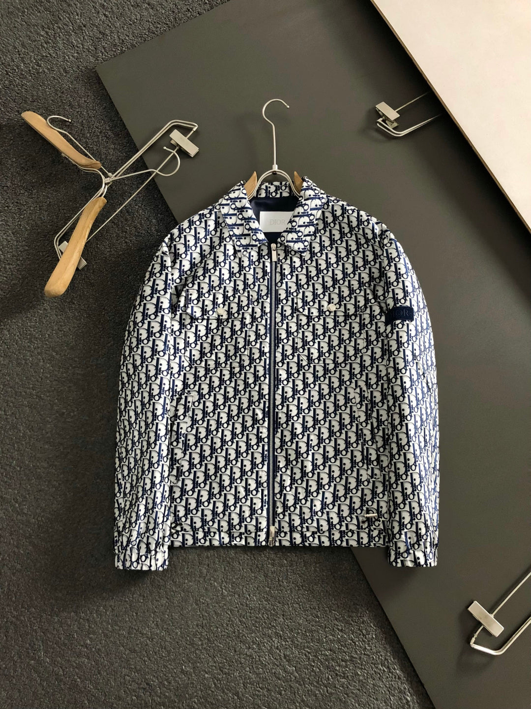 Long-sleeve zip jacket with Dior monogram print, front view on hanger.