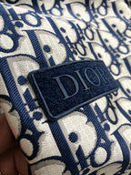 Long Dior logo garment in blue and cream, close-up fabric patch