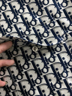 Close-up of Dior monogram jacket zipper seam with metal pull tab.