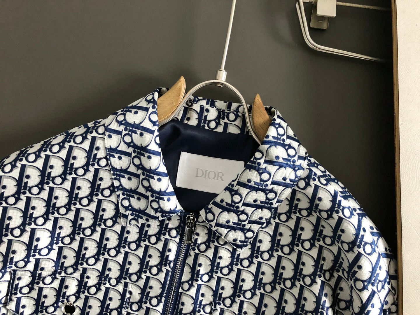 Dior monogram zip jacket collar and front, shown on a hanger.