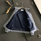 Long-sleeve Dior monogram jacket laid open, showing inner lining in dark blue.