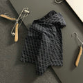 Black zip-up jacket with allover geometric logo pattern and full sleeves