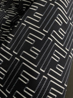 Black and off-white geometric logo pattern fabric