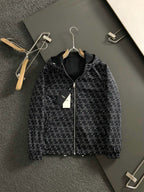 Black zip jacket with repeating geometric logo print and front zipper
