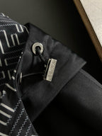 Black jacket hood cord lock with metal toggle detail