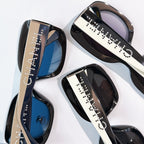 Chanel sunglasses close-up with studded logo temples and tinted lenses in blue and dark tones