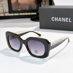 Chanel sunglasses with black frames and purple gradient lenses, studded logo temples