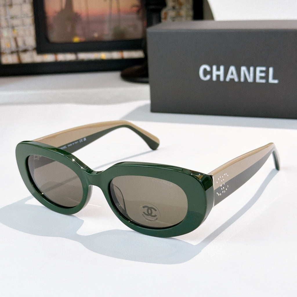 Chanel sunglasses with green frames, cream temples, gray lenses and logo emblem detail