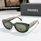 Chanel sunglasses with green frames, cream temples, gray lenses and logo emblem detail
