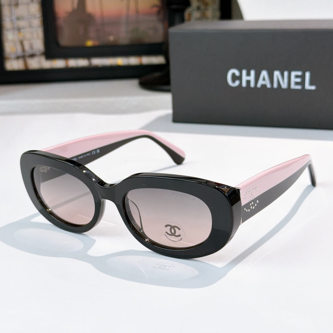 Chanel sunglasses with black frames, pink accent temples, rose tinted lenses and logo detail