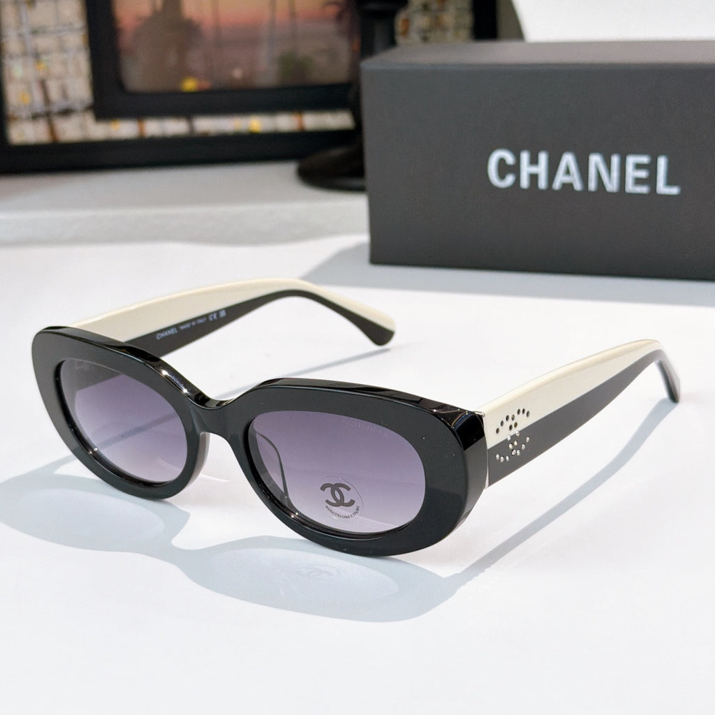 Chanel sunglasses with black frames, cream temples, purple tinted lenses and logo detail