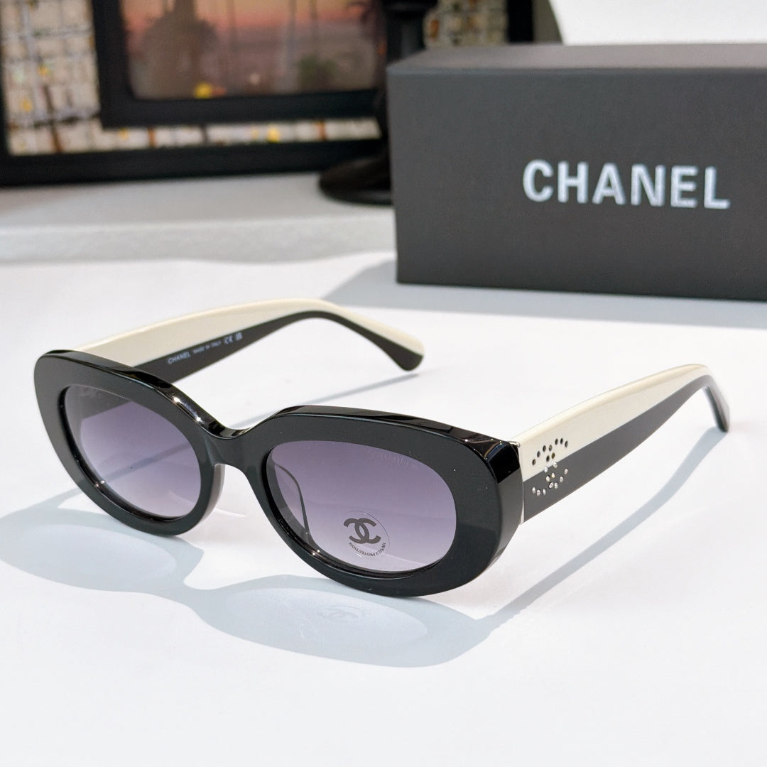 Chanel sunglasses with black frames, cream temples, purple tinted lenses and logo detail