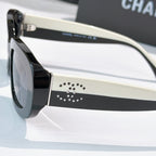 Chanel sunglasses side view with black frames, cream temples, studded logo detail