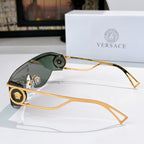 Gold-tone sunglasses with dark lenses and round emblem accents on temples