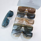 Multiple pairs of sunglasses with dark lenses, stacked on display