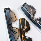 Two sunglasses with dark and blue-tinted lenses, metal frames, and logo details