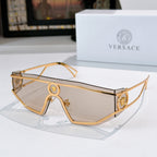 Gold-tone sunglasses with gray-brown lenses, cutout bridge, and round logo medallions
