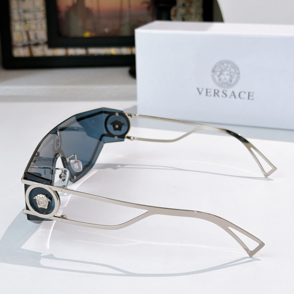Silver-tone sunglasses with gradient blue-tinted lenses and round logo accents