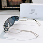 Silver-tone sunglasses with gradient blue-tinted lenses and round logo accents