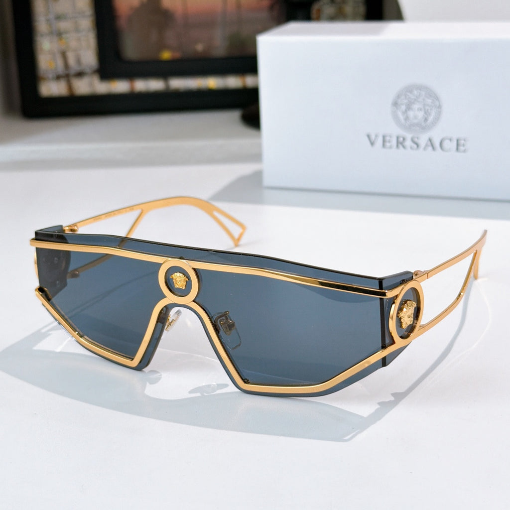 Gold-tone oversized sunglasses with blue tinted lenses and oval logo bridge details