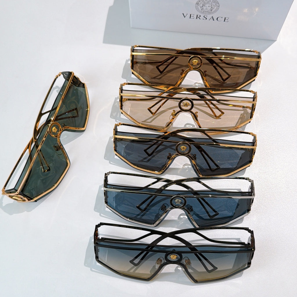 Stack of four oversized sunglasses with geometric metal frames and tinted lenses