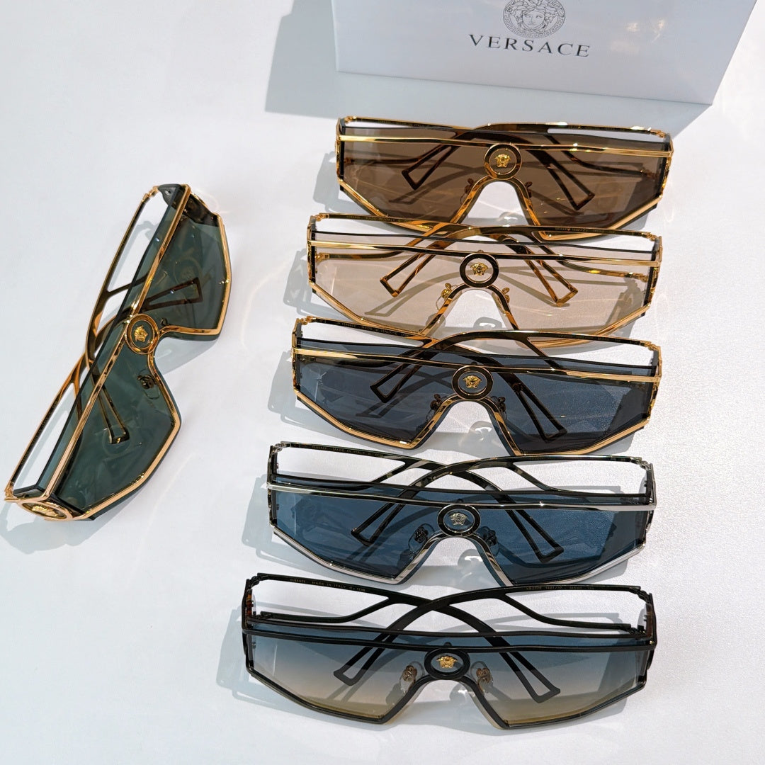 Stack of four oversized sunglasses with geometric metal frames and tinted lenses