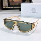 Gold-tone sunglasses with teal tinted lenses and oval logo bridge accents
