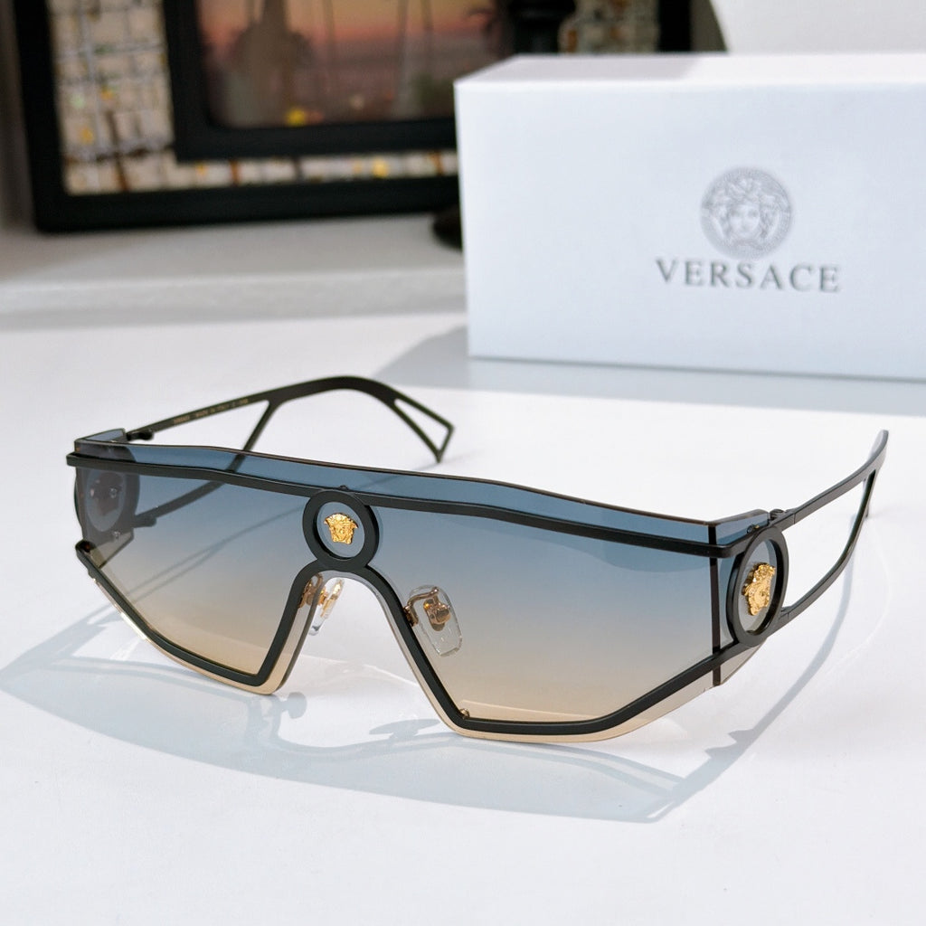 Black-tone oversized sunglasses with blue tinted lenses and oval logo medallions