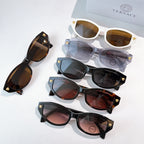 Assorted cat-eye sunglasses with mixed frames and lenses, including white and tortoiseshell