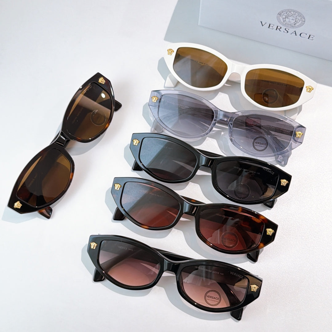 Assorted cat-eye sunglasses with mixed frames and lenses, including white and tortoiseshell
